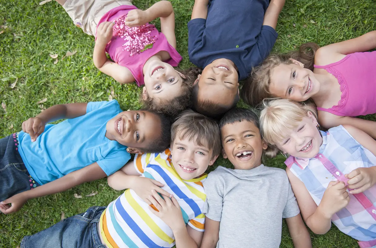 Kids lying in circle and smiling