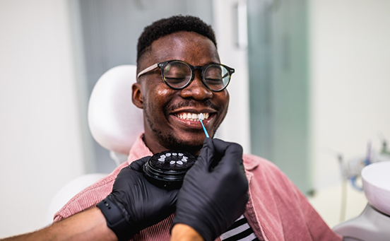 Male patient with glasses having veneers placed