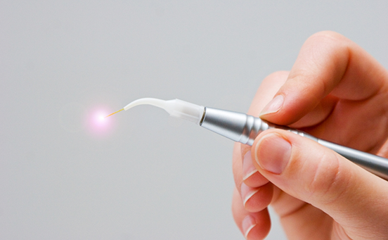 Close-up of hand holding soft tissue laser