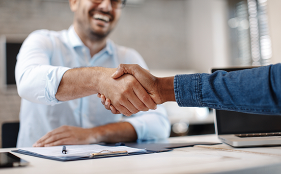 Dentist and patient shaking hands