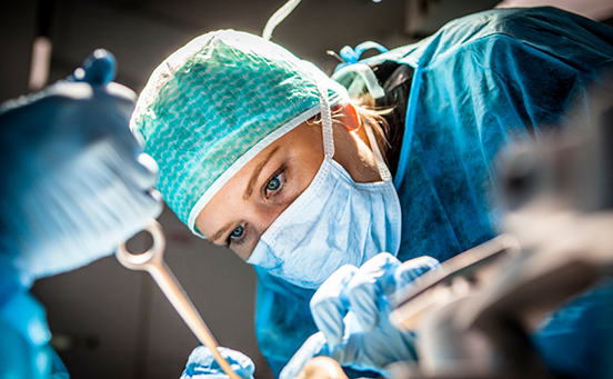 Close up of dentist with mask treating patient