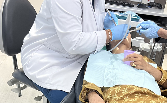 Female patient having teeth treated by Dr. Peravali