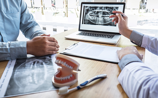 Showing patient dental X-ray on a laptop