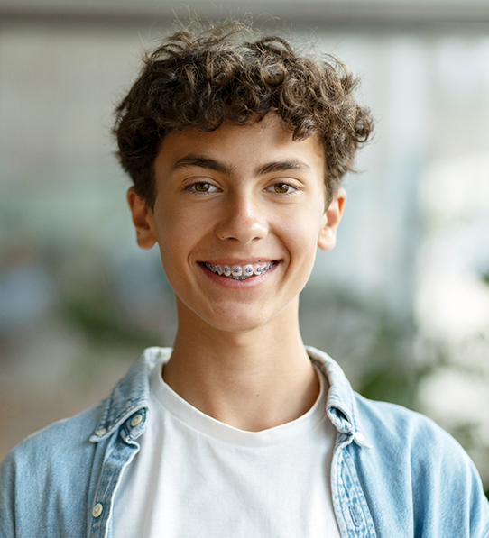 Boy in denim jacket with braces