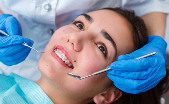 Woman with braces lying back in dental chair