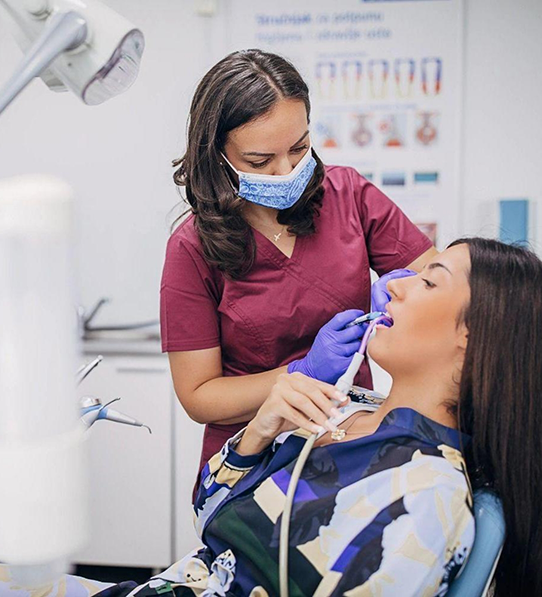 Female dentist treating a female patient